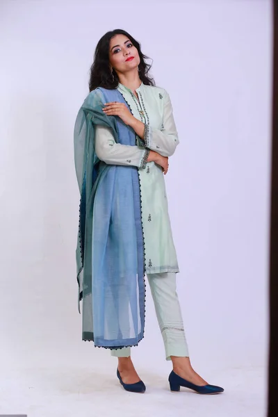 Beautiful Pakistani Woman in traditional embroidery shalwar kameez dress with dupatta. `Desi Fashion Concept