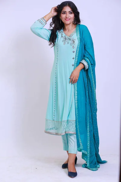 Beautiful Pakistani Woman in traditional embroidery shalwar kameez dress with dupatta. `Desi Fashion Concep