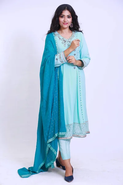 Beautiful Pakistani Woman in traditional embroidery shalwar kameez dress with dupatta. `Desi Fashion Concep