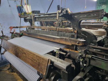 Endüstriyel kumaş üretim hattı. Bir tekstil fabrikasında dokuma tezgahı