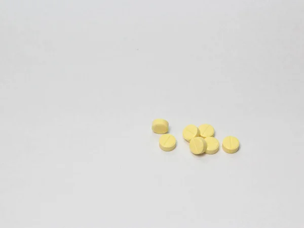 yellow pill isolated on white as vitamins, supplements, aspirin