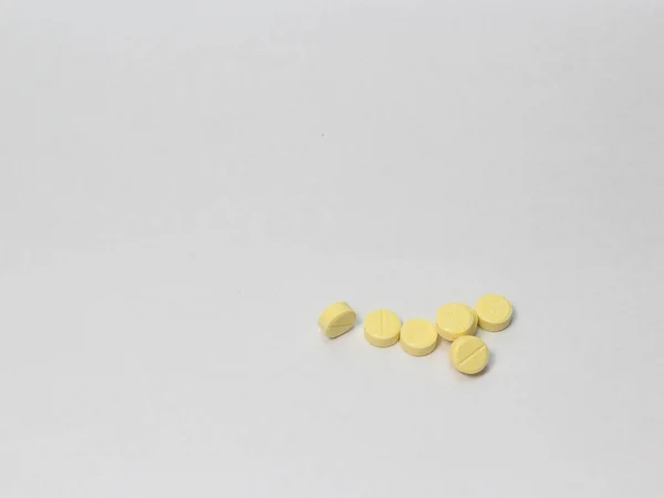 yellow pills isolated on white background, view top