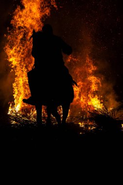 16 January 2025, Knights cross bonfires with their horses in an ancient tradition of purification, 