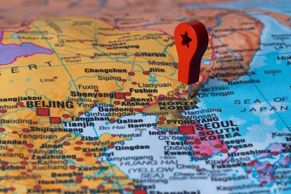 Red pin, point on the map of North korea. Concept travel background