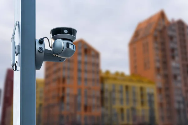 Modern public CCTV camera with blur building background. Recording cameras for monitoring all day and night. Concept of surveillance and monitoring with copy space