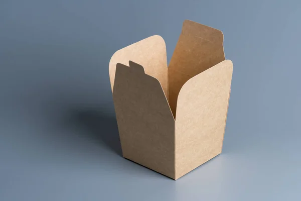 Open cardboard box on grey background