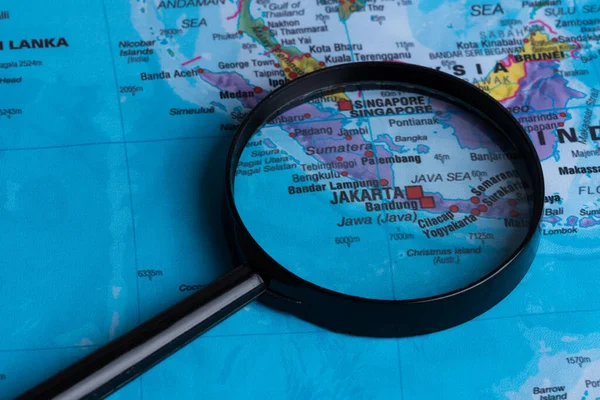 Map of Jakarta through magnifying glass.Close-up