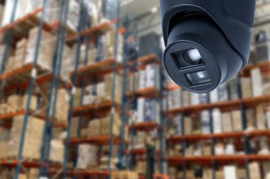 CCTV Camera Operating inside warehouse or factory. Copy space