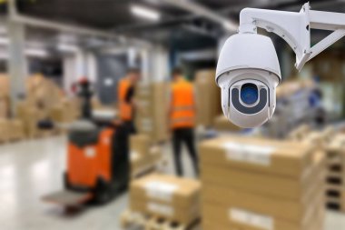 CCTV Camera Operating inside warehouse or factory. Copy space
