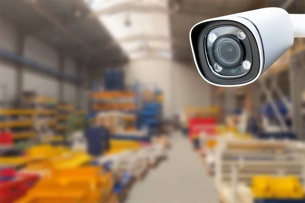CCTV Camera or surveillance operating inside industrial factory. Copy space