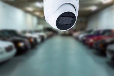 CCTV security camera on blur car parking. Copy space