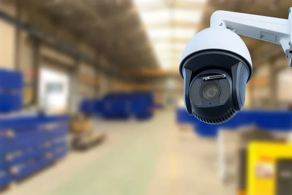 CCTV Camera or surveillance operating inside industrial factory. Copy space
