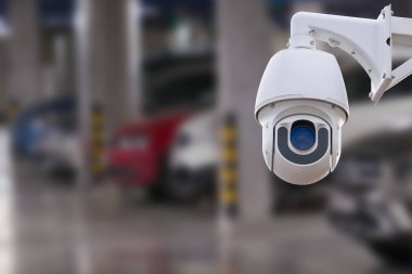 CCTV camera in underground parking garage. Copy space