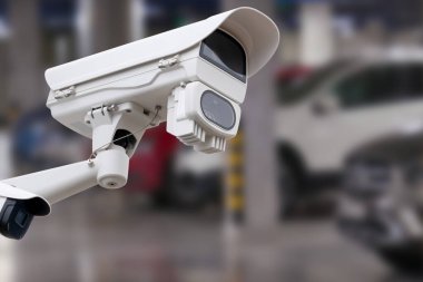 CCTV camera in underground parking garage. Copy space
