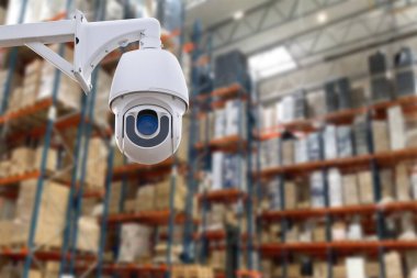 CCTV Camera Operating inside warehouse or factory. Copy space