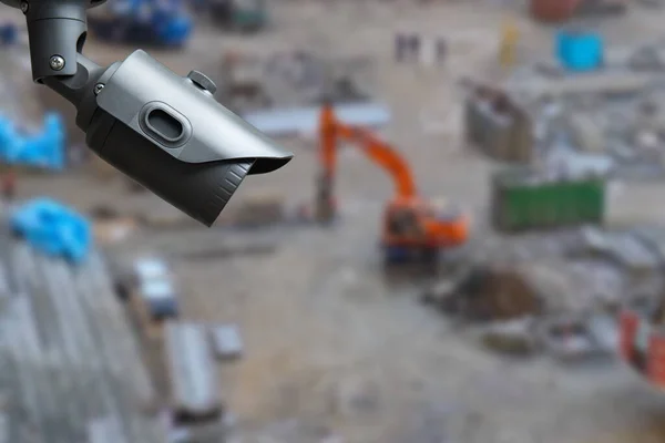 security CCTV camera or surveillance system with construction site on blurry background