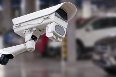 CCTV camera in underground parking garage. Copy space