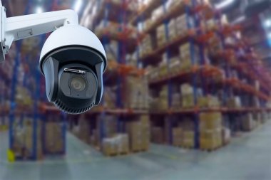 CCTV Camera Operating inside warehouse or factory. Copy space