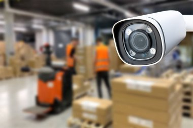 CCTV Camera Operating inside warehouse or factory. Copy space