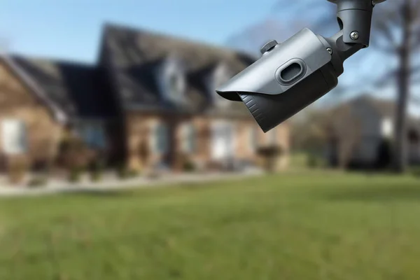 CCTV Camera or surveillance operating with house village in background