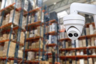 CCTV Camera Operating inside warehouse or factory. Copy space