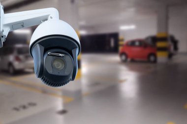 CCTV camera in underground parking garage. Copy space