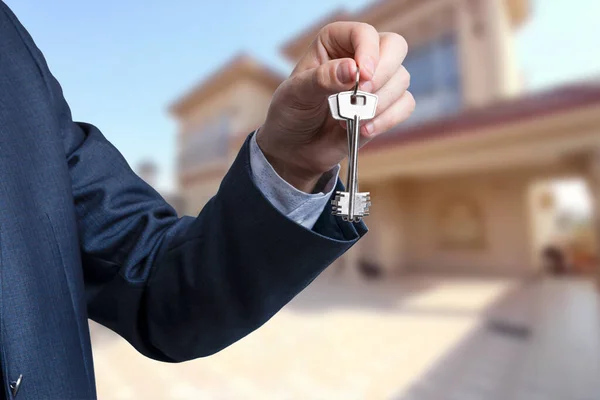 stock image Man hand holding on finger keys to new house