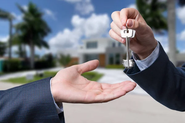 stock image Landlord unlocks the house key for new home