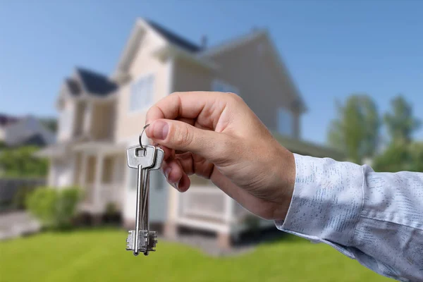 stock image Man hand holding on finger keys to new house