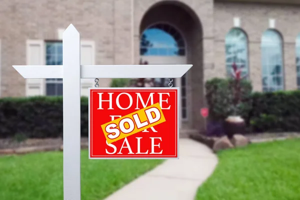 Sold Home For Sale Real Estate Sign in Front of Beautiful New House