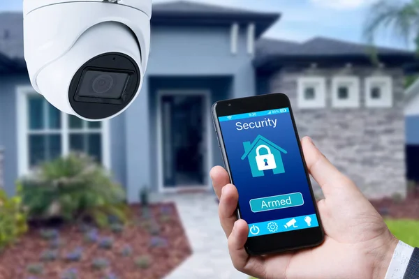 Security camera and smart home app, private house on the background