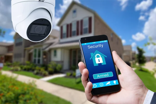 Security camera and smart home app, private house on the background
