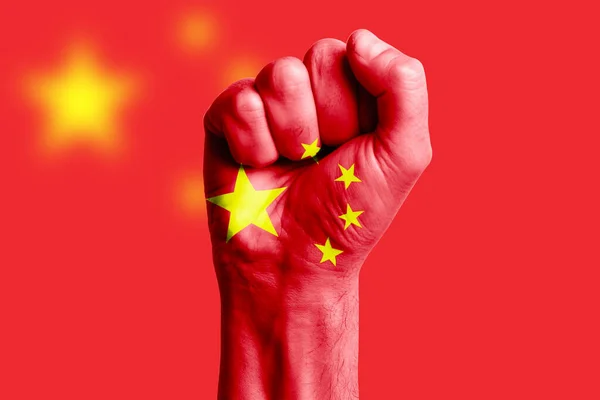 Man hand fist of CHINA flag painted. Close-up