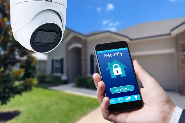 Security camera and smart home app, private house on the background
