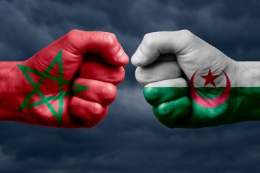 MoroCCO, ALGERYA 'ya karşı mücadele, dini çatışma. MoroCCO ve ALGERIA 'nın boyanmış bayraklarıyla erkeklerin yumrukları