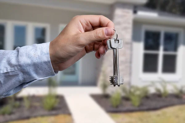 Man hand holding on finger keys to new house