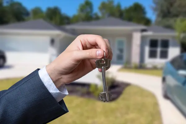 Man hand holding on finger keys to new house