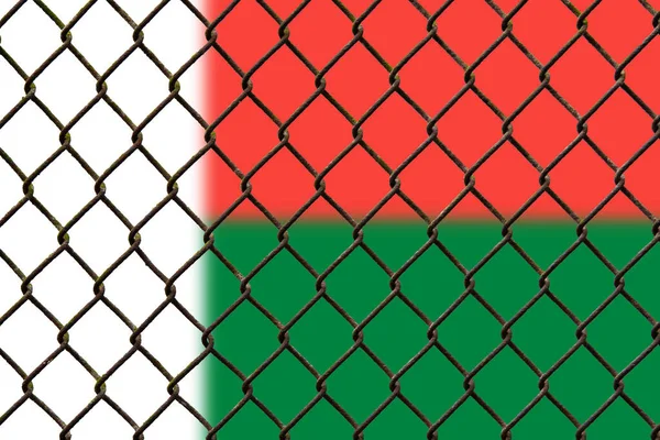A steel mesh against the background of the flag Madagascar