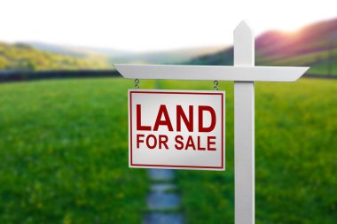 Konut geliştirme ve inşaat geçmişi için yeşil çimenlik alanda satılık tabela