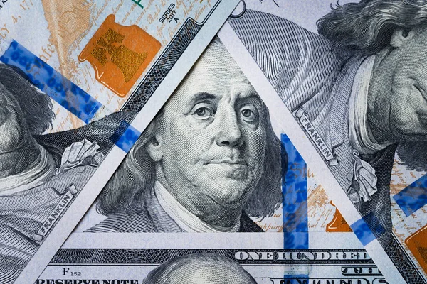 Benjamin Franklin\'s eyes from a hundred-dollar bill. The face of Benjamin Franklin on the hundred dollar banknote, backgrounds, close-up. 100 dollar bill with only eyes of Benjamin Franklin