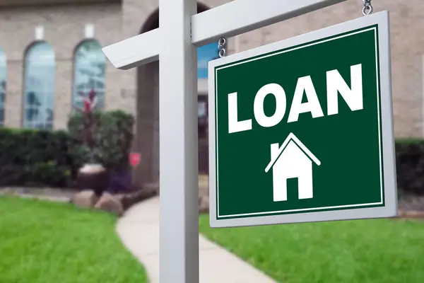 LOAN sign against a house. Close-up