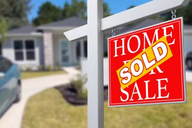 Sold Home For Sale Real Estate Sign in Front of Beautiful New House clipart