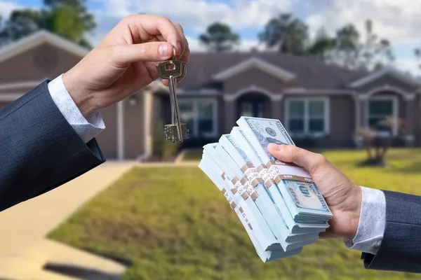 stock image Man Handing a man Thousands of Dollars For Keys in Front of House