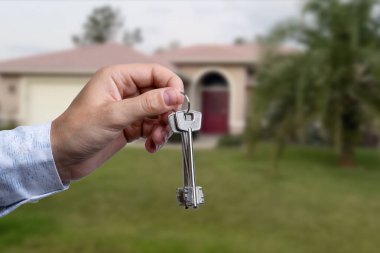 Yeni evin anahtarlarına parmak üzerinde tutan adam el