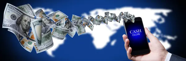Cash flow of 100 dollar bills from a mobile phone in the hands of a businessman. On a blue background