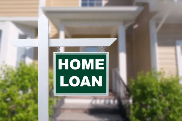 HOME LOAN sign against a house. Close-up