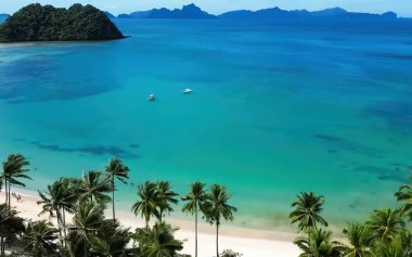 Havadan bakıldığında turkuaz okyanus suyu ve zengin palmiye ormanlarıyla sakin tropikal kıyılar..