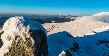 Nearest hills of Nizke Tatry, mountain peaks of Zapadne Tatry and lower hills of Chocske vrchy mountains from Durkova hill in winter Nizke Tatry mountains in Slovakia