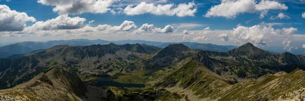 Aamazing mountain panorama with many peaks and hills from highest mountain peak of Retezat mountains - Varful Peleaga in Romania