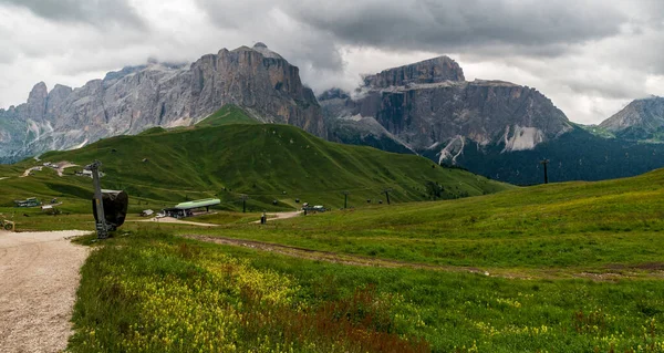 Sella mountain group from hiking trail between Passo Sella and Col Rodella in the Dolomites during cloudy summer day